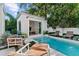 Gorgeous backyard pool with a guest house featuring stylish lounge furniture and manicured landscaping at 1150 Via Salerno, Winter Park, FL 32789