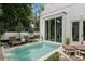 Relaxing backyard pool area featuring sleek lounge chairs, lush landscaping, and direct access to the home at 1150 Via Salerno, Winter Park, FL 32789