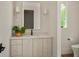 Powder room featuring white vanity with sconces and decorative mirror at 1150 Via Salerno, Winter Park, FL 32789