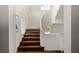 Bright staircase with wooden steps, white walls, and natural light from a large window at 1150 Via Salerno, Winter Park, FL 32789
