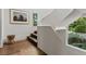 Bright staircase with wooden steps, white walls, and natural light from a large window at 1150 Via Salerno, Winter Park, FL 32789