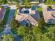 Stunning aerial view of a luxury home featuring a private pool, lush landscaping, and a tile roof at 11754 Waterstone Loop Dr, Windermere, FL 34786