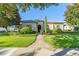 Beautiful one-story home with a landscaped front yard, brick walkway, and a well-manicured lawn at 11754 Waterstone Loop Dr, Windermere, FL 34786