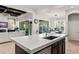 Spacious kitchen island features marble countertops and stainless steel appliances, with an adjacent living area at 11754 Waterstone Loop Dr, Windermere, FL 34786
