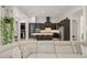 Modern kitchen with dark cabinetry, a center island with seating, stainless steel appliances, and open layout at 11754 Waterstone Loop Dr, Windermere, FL 34786