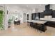 Open-concept kitchen with a large island, bar seating, and modern appliances connected to dining area at 11754 Waterstone Loop Dr, Windermere, FL 34786