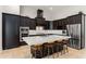 Gourmet kitchen with dark wood cabinets, stainless steel appliances, an oversized island with seating, and sleek design at 11754 Waterstone Loop Dr, Windermere, FL 34786