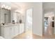 Bright main bathroom with a double vanity and a view of the toilet and shower at 11754 Waterstone Loop Dr, Windermere, FL 34786