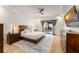 Comfortable main bedroom featuring a ceiling fan, dark wood accents, and sliding glass doors to the lanai at 11754 Waterstone Loop Dr, Windermere, FL 34786