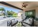 Relaxing outdoor patio with plush seating, ceiling fan, and views of a stunning pool at 11754 Waterstone Loop Dr, Windermere, FL 34786