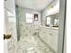 Bright bathroom with a glass-enclosed shower, marble tile, and double vanity at 1212 Bradwell Dr, Orlando, FL 32837