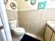 Cozy half bathroom with tan tiling and blue accents at 1212 Bradwell Dr, Orlando, FL 32837