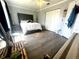 Bedroom featuring a queen bed, light-filled window and wood-look flooring at 1212 Bradwell Dr, Orlando, FL 32837