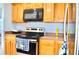 Functional kitchen with stainless steel appliances, tile floors and wooden cabinets at 1212 Bradwell Dr, Orlando, FL 32837
