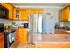 Functional kitchen with stainless steel appliances, tile floors and wooden cabinets at 1212 Bradwell Dr, Orlando, FL 32837