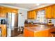 Functional kitchen with stainless steel appliances, tile floors and wooden cabinets at 1212 Bradwell Dr, Orlando, FL 32837