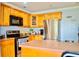 Functional kitchen with stainless steel appliances, tile floors and wooden cabinets at 1212 Bradwell Dr, Orlando, FL 32837