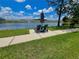 Relaxing lake view with an umbrella table and chairs at 1212 Bradwell Dr, Orlando, FL 32837