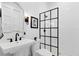 Modern bathroom with sleek black fixtures, a glass-enclosed shower, and elegant tiling at 1410 W New Hampshire St, Orlando, FL 32804