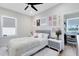Cozy bedroom with a ceiling fan, closet, and stylish decor including neutral colored furnishings at 1410 W New Hampshire St, Orlando, FL 32804