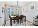 Cozy dining room featuring a modern chandelier, large windows, and a stylish area rug at 1410 W New Hampshire St, Orlando, FL 32804