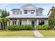 Charming two-story home with a manicured lawn and covered porch with decorative columns at 1410 W New Hampshire St, Orlando, FL 32804