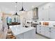 Modern kitchen with white cabinetry, stainless steel appliances, and an island with bar seating at 1410 W New Hampshire St, Orlando, FL 32804
