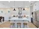 Bright kitchen with stainless steel appliances, a large island, and modern pendant lighting at 1410 W New Hampshire St, Orlando, FL 32804