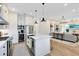Bright, modern kitchen features stainless appliances, a center island, and an open view to the living space at 1410 W New Hampshire St, Orlando, FL 32804
