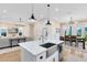 Open kitchen with white marble countertops, stainless steel appliances, and a large center island at 1410 W New Hampshire St, Orlando, FL 32804