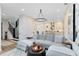 Open concept living space flows into the kitchen and showcases a staircase with black banister at 1410 W New Hampshire St, Orlando, FL 32804