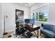 Well-lit home office with a modern desk setup, stylish decor, and a comfortable accent chair at 1410 W New Hampshire St, Orlando, FL 32804