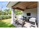 Inviting covered patio features comfortable seating, a ceiling fan, and an outdoor grill, perfect for entertaining at 1410 W New Hampshire St, Orlando, FL 32804