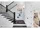 Staircase featuring black banister and wooden steps leading to the upper floor with built in shelves at 1410 W New Hampshire St, Orlando, FL 32804