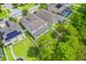 An aerial view shows a home with a covered patio and a lush backyard surrounded by trees at 1639 Balsam Willow Trl, Orlando, FL 32825