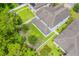 Aerial view of a two story home with a grey roof and a backyard surrounded by a white fence at 1639 Balsam Willow Trl, Orlando, FL 32825