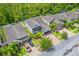 An aerial view shows a two story home with lush trees, manicured lawn, and a brick driveway at 1639 Balsam Willow Trl, Orlando, FL 32825