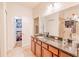 Well-lit bathroom with a granite countertop, ample cabinetry, and tile flooring at 1639 Balsam Willow Trl, Orlando, FL 32825