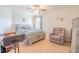 Comfortable bedroom featuring carpet, a ceiling fan, and a cozy seating area at 1639 Balsam Willow Trl, Orlando, FL 32825