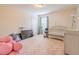 Bedroom with a crib, a ceiling fan and light, and a neutral color scheme at 1639 Balsam Willow Trl, Orlando, FL 32825