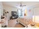 Comfortable bedroom featuring a large television, carpeted floors, and a window with blinds at 1639 Balsam Willow Trl, Orlando, FL 32825