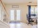 Bright foyer featuring double doors with decorative glass and tile flooring throughout at 1639 Balsam Willow Trl, Orlando, FL 32825