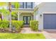 Inviting front entrance with double doors, manicured hedges, and a paved walkway to a two-car garage at 1639 Balsam Willow Trl, Orlando, FL 32825