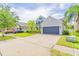 A well-maintained two-story home with brick driveway, lush greenery, and a two-car garage at 1639 Balsam Willow Trl, Orlando, FL 32825