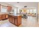 Modern kitchen with granite countertops, stainless steel appliances, and an island overlooking the living area at 1639 Balsam Willow Trl, Orlando, FL 32825
