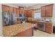Well-lit kitchen with granite countertops, stainless steel appliances, and custom cabinetry at 1639 Balsam Willow Trl, Orlando, FL 32825