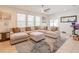 Bright living area with a comfortable sectional sofa, large windows, and access to the outdoor patio at 1639 Balsam Willow Trl, Orlando, FL 32825
