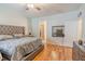 Spacious main bedroom featuring a decorative headboard and hardwood flooring at 1639 Balsam Willow Trl, Orlando, FL 32825