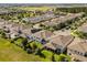 An aerial view of a residential community with modern homes, manicured lawns, and tree-lined streets at 16564 Silversaw Palm Dr, Winter Garden, FL 34787