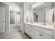Bathroom featuring a double sink vanity, tile flooring, and a shower-tub combination at 16564 Silversaw Palm Dr, Winter Garden, FL 34787